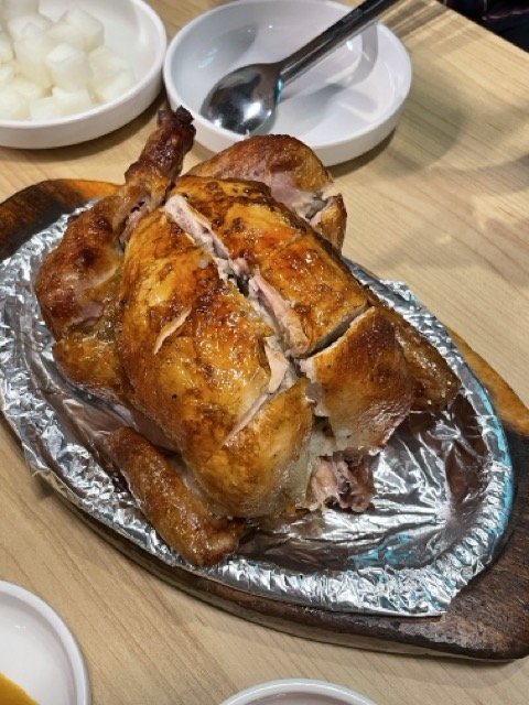 나무 도마 위에 통째로 올려진 장작 통닭